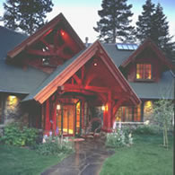 The welcoming entrance of a large home makes beautiful use of redwood timbers and redwood siding.
